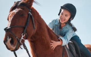How To Enjoy Horseback Riding in Fredericksburg, TX: A little girl is riding a horse